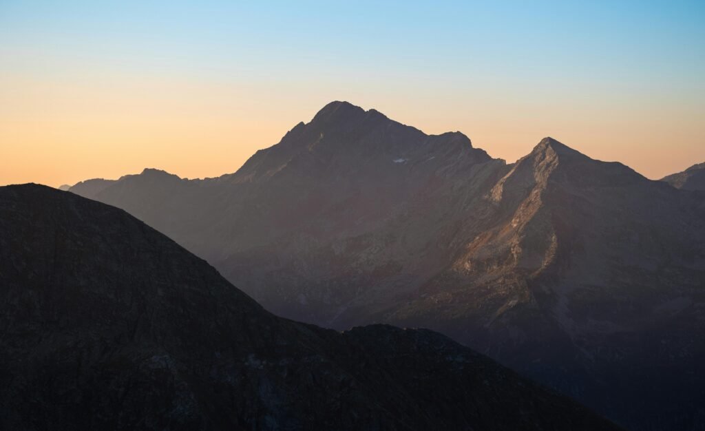 41summits-peak-sunrise a single peak backlit by the sunrise